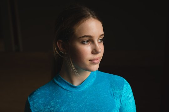 Ballerina looking away at dance studio