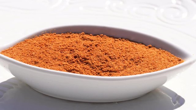 Dry spices paprika on a rotary table. 4K. Macroshooting.