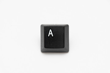 Single black keys of keyboard with different letters A