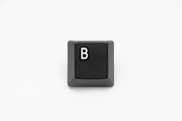 Single black keys of keyboard with different letters B