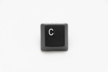 Single black keys of keyboard with different letters C
