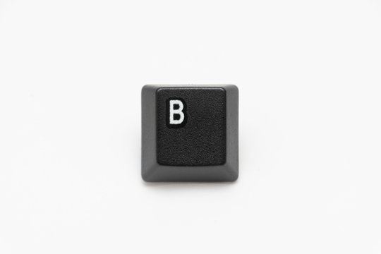 Single black keys of keyboard with different letters B