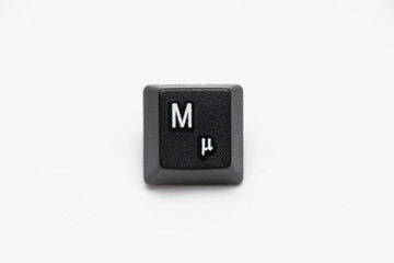 Single black keys of keyboard with different letters M