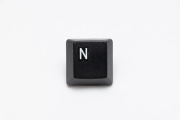 Single black keys of keyboard with different letters N