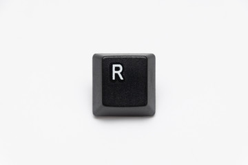Single black keys of keyboard with different letters R