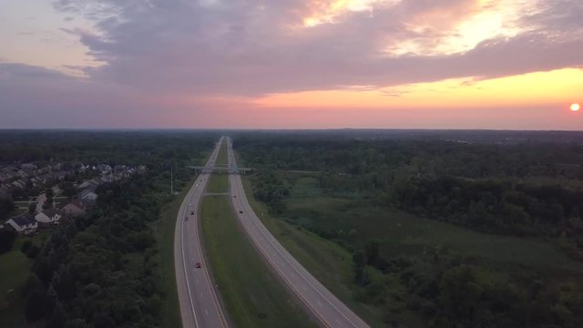 Drone shot of a highway at sunset