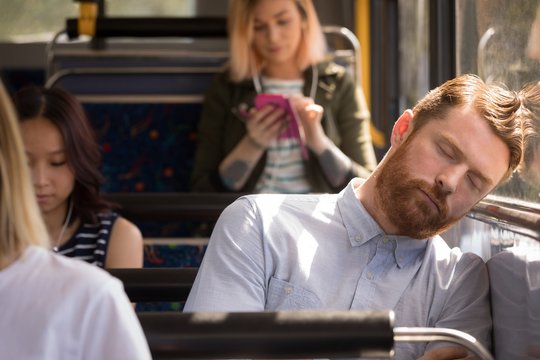 Man sleeping while traveling in bus