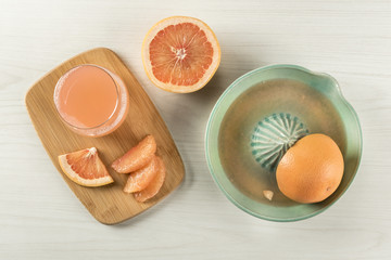 Grapefruits being squeezed in juicer