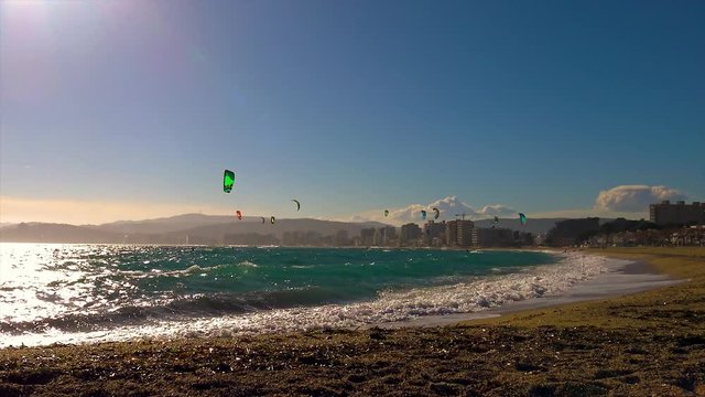 Many Kite Surfers in a sunny day in Spain, in Costa Brava, near the town Palamos