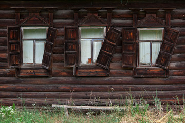 Windows of an old wooden hut in the village