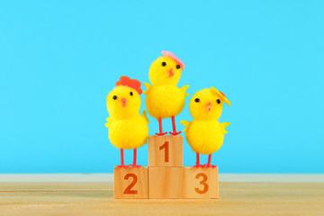 Three chicken on a pedestal. The first, second and third place.