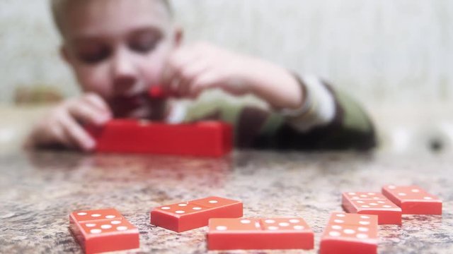 Childhood memories. Caucasian child baby boy toddler playing dominoes