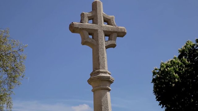 Cross at top of war memorial in English churchyard