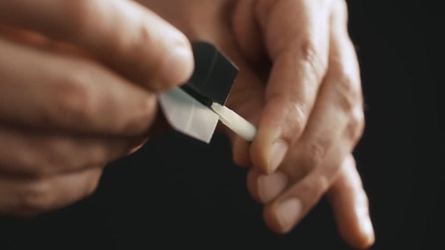 Slow motion Darts player preparing a dart for the game, 4k