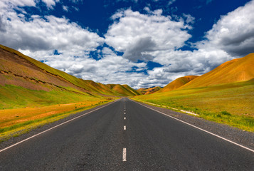 Asphalt road. Mountain road. Beautiful landscape. An empty road. Blue sky. Mountain landscape.