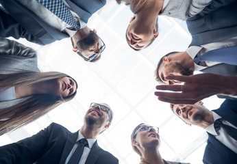 bottom view.a group of business people is forming a circle
