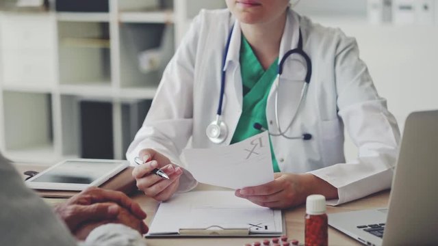 Doctor giving prescription to patient