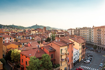 Bologna, Emilia Romagna, Italy. The roofs of city at sunset: Basilica of San Luca on the background. © GiorgioMorara