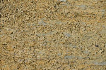 Natural rock structure background or texture. Lined rock with different natural colors.