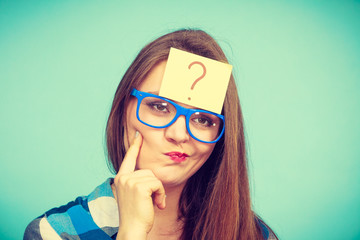 Thinking woman with big eyeglasses and light bulb