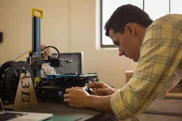 Mechanic using die machine on table
