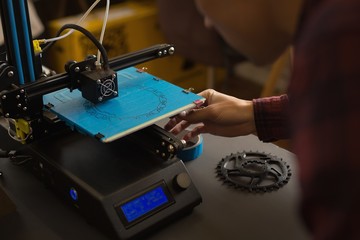 Mechanic working on die machine on table