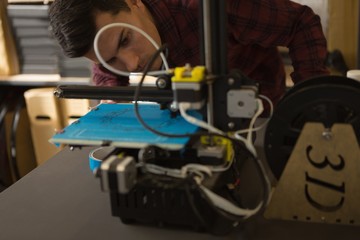 Mechanic working on die machine on table