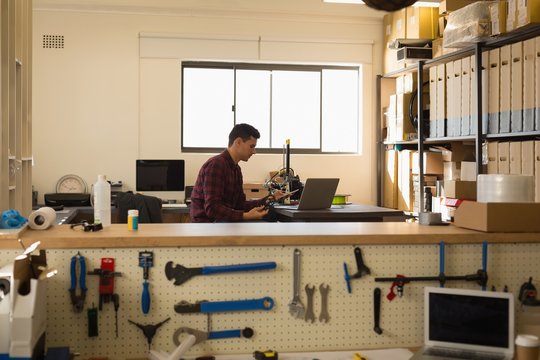 Mechanic using mobile phone on desk