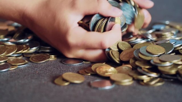 Coins in hands. Money concept.