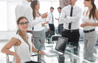 young business woman sitting in front of open laptop