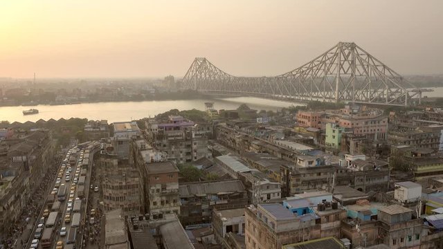 Beautiful sunset view of Kolkata city with a Howrah bridge on the Ganga river, West Bengal, India.