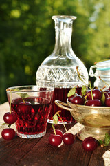 cherry liqueur in crystal carafe and fresh fruits