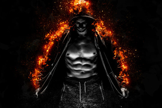 Strong young man with muscular body in burning black sport jacket with hood. Concept Power Body