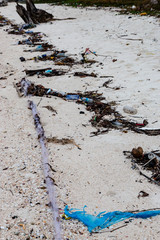Large amounts of plastic and other rubbish washed up on the high tide line on a remote tropical beach