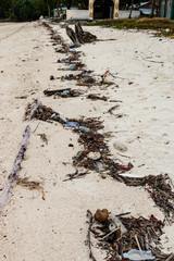 Large amounts of plastic and other rubbish washed up on the high tide line on a remote tropical beach