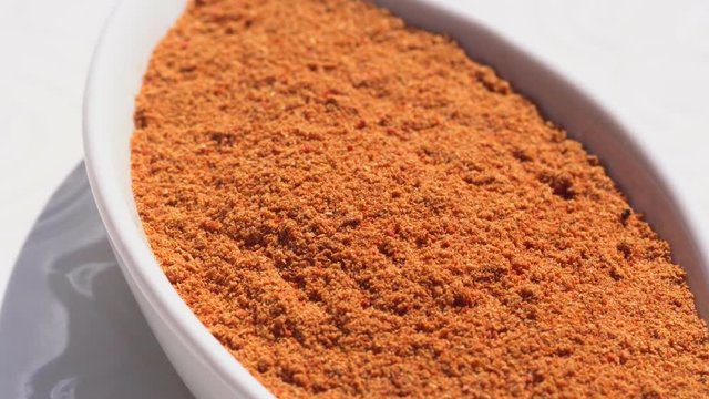 Dry spices paprika on a rotary table. 4K. Macroshooting.