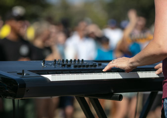 Keyboard in outdoor park concert bokeh audience