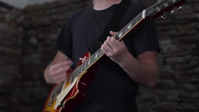 Man playing his Les Paul style guitar - wide body shot