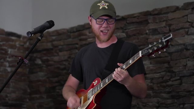 Musician rocking out while playing his guitar