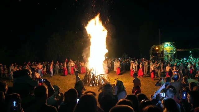 Nemirintsy, Ukraine-July 6, 2017: Ethnic national folk holiday Ivan Kupala, traditional celebration . European Ukrainian Slavic folk dances around a huge great fire. Festive folk show, concert perform