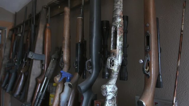 guns on a rack in a hunting camp