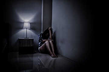 Depression woman alone in the dark room. Mental health problem, PTSD is Post-traumatic stress...