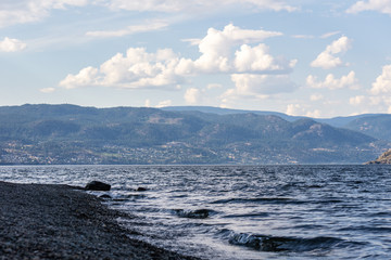 Okanagan lake at summer day with clouds on the sky.