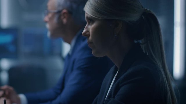 Female Chief Financial Officer Listens to a Team of Corporate Executives and Government Officials in the Meeting Room. Serious Business People Talking and Negotiating.