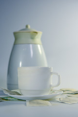 Cup of tea with tea bag on white background.