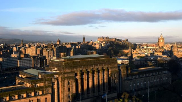 Early morning hours, sunrise at Calton Hill in Edinburgh. Showing the skyline of Edinburgh, including the Clocktower, the Castle and parliament. slide version
