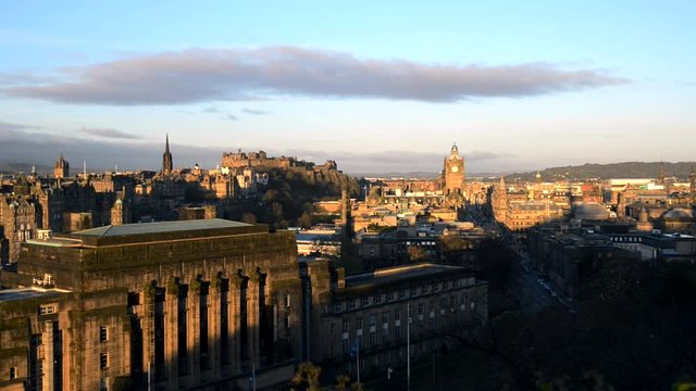 Early morning hours, sunrise at Calton Hill in Edinburgh. Showing the skyline of Edinburgh, including the Clocktower, the Castle and parliament. Static camera