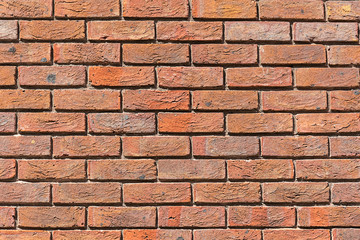 Background from an uniformly red brick wall