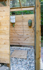 Outdoor shower stall at a glamping site