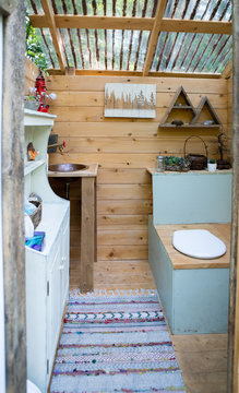 Outdoor composting toilet stall at a glamping site